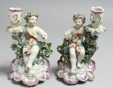A GOOD PAIR OF DERBY CANDLESTICKS, figures of children.