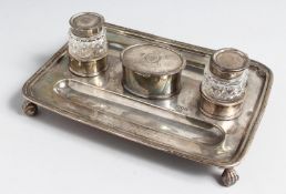 A SILVER INKSTAND by H WOODWARD & CO., London, 1913, with two silver top cut glass inkwells and oval
