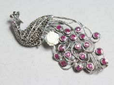 A SILVER, RUBY AND MARCASITE PEACOCK BROOCH.