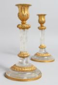 A PAIR OF GILT BRONZE MOUNTED ROCK CRYSTAL CANDLESTICKS. 7.5ins high.