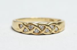 AN 18CT GOLD DIAMOND SET PLAIT RING.