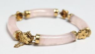 A 14CT GOLD AND PINK QUARTZ BRACELET.
