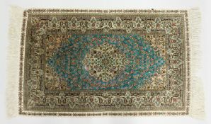 A SMALL PERSIAN SILK RUG, pale blue ground with fine floral design. 4ft x 2ft 6ins.