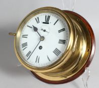 A BRASS CIRCULAR SHIP'S WALL CLOCK, 6ins dial, from the Troop Ship 