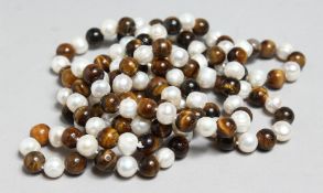 A STRING OF PEARL AND TIGER'S EYE BEADS, 45ins long.