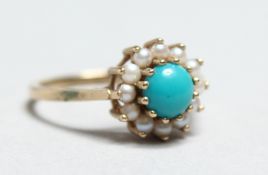 A 9CT GOLD TURQUOISE AND PEARL RING.