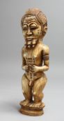 AN IMPRESSIVE EARLY 20TH CENTURY CONGO CARVED IVORY STANDING MALE NUDE. 11ins high.