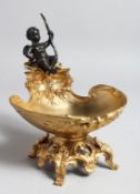 A GILT BRONZE TABLE SALT mounted with a cherub. 7ins high.