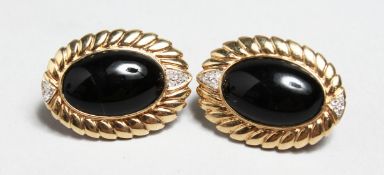 A PAIR OF OVAL 14CT GOLD, ONYX AND DIAMOND EARRINGS.