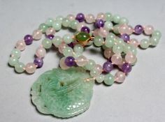 A CHINESE MULTI-COLOURED JADE NECKLACE with carved fish pendant, 30ins long.