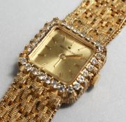 A LADIES 18CT GOLD GOLDEN CROWN WRISTWATCH with diamond surround. Weighs 62gms including movement.