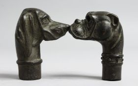 TWO BRONZE DOG'S HEAD WALKING STICK HANDLES.