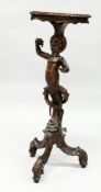 AN 18TH / 19TH CENTURY ITALIAN CARVED WALNUT BLACKAMOOR TORCHERE of typical form, with a shaped top,