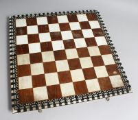 A CHESS SET in a wooden box, with black and white ivory chess pieces.