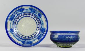 A BOHEMIAN BLUE TINTED BOWL AND STAND with a landscaped decoration.
