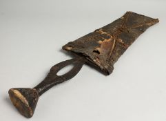 A TRIBAL WEAPON in a sheath.