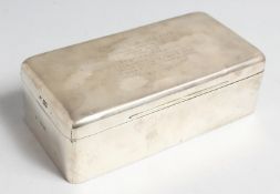 A SILVER RECTANGULAR CIGARETTE BOX with doomed top and rounded corners, 8ins long, London,1990.