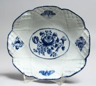 AN 18TH CENTRUY BOW BASKET WEAVE MOULDED DISH painted with flowers in underglaze blue.