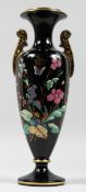 A LATE VICTORIAN TWIN HANDLED POTTERY PEDESTAL VASE, black ground, enamel and gilt decorated with