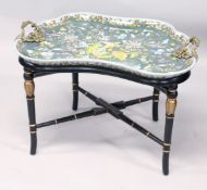 AN UNUSUAL PORCELAIN TRAY TOP TABLE with ormolu handles on an ebonised and gilded base. 30ins long x