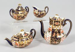 A MINIATURE CROWN DERBY PART SERVICE comprising teapot, coffee pot, sucrier and milk jug, teapot