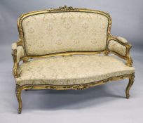 A 19TH CENTURY FRENCH GILTWOOD FRAMED CANAPE, with carved frame and classical cream upholstery.