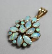 A GOLD PENDANT MOUNTED WITH NUMEROUS OPALS.