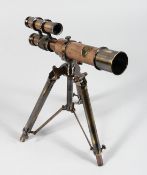 A LEATHER COVERED BRASS TELESCOPE ON TRIPOD STAND. 10ins long.