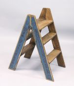A PAIR OF FOLDING PINE STEPS, painted to the sides with champagne makers on a blue background