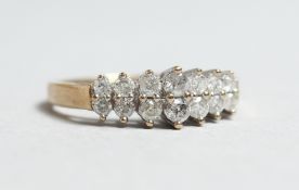 A GOLD AND DIAMOND TWO ROW RING.
