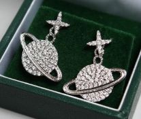 A PAIR OF SILVER PLANET EARRINGS.
