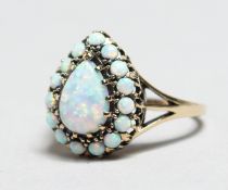 A 9CT GOLD PEAR SHAPED OPAL RING.
