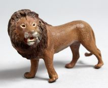 A SMALL VIENNA STYLE COLD PAINTED BRONZE MODEL OF A LION, 4ins long.