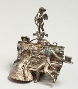 A CAST SILVER GROUP, man and women on a bench. 4cm long.