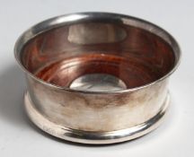 A SILVER WINE COASTER.