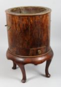 A CIRCULAR WOOD JARDINIERE on four curving legs with brass liner. 19ins high