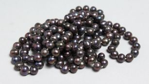 A STRING OF BLACK PEARLS, 46ins long.