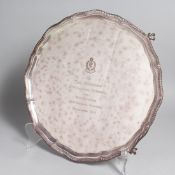A SILVER PLATED PIE CRUST SALVER with a gadrooned edge on four claw and ball feet, 14ins diameter,