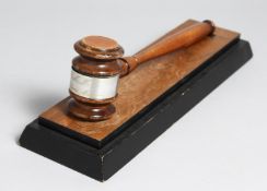 AN RAMC OFFICERS MESS GAVEL ON STAND.