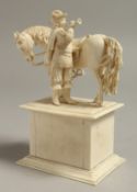 A GOOD EUROPEAN IVORY GROUP OF A MAN BLOWING A TRUMPET standing beside a horse
