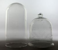 A BELL SHAPED GLASS DOME/COVER with engraved decoration, together with a plain glass dome. 8.5ins