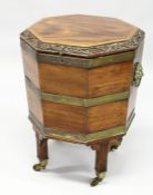 A GOOD GEORGE III MAHOGANY OCTAGONAL SHAPED CELLERETTE the rising top with carved edge, brass