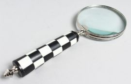 A MAGNIFYING GLASS with CHEQUERED handle.