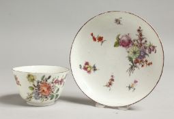 AN 18TH CENTURY CHELSEA RED ANCHOR MARKED TEA BOWL AND SAUCER painted with Meissen style flowers.