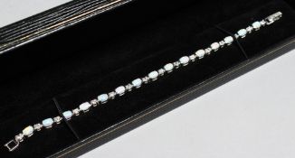 A SILVER AND OPAL HIVE BROOCH.