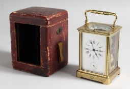 A GOOD FRENCH ENGRAVED BRASS CARRIAGE CLOCK with eight day movement, striking on a gong, enamel dial