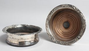 A PAIR OF WILLIAM IVTH SILVER WINE COASTER with cast rims and turned wood bases, London, 1829-