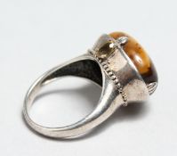 A SILVER AND TIGER'S EYE RING.