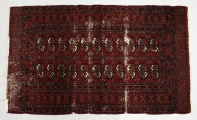 A BOKHARA RUG, red ground with two rows of eleven gulls (worn). 5ft 4ins x 3ft 2ins.