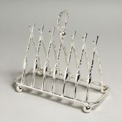 A SILVER PLATED SIX DIVISION TOAST RACK with cross rifles.